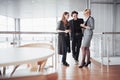 Young male and female coworkers discussing and planning productive working process in office, smiling students