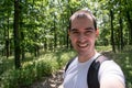 young male in forest take selfie closeup happy man enjoy life summer smile freedom