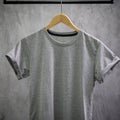 Young male in front blank black t-shirt Roll up sleeves template, Three color black white gray hang on cement background for your Royalty Free Stock Photo