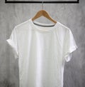 Young male in front blank black t-shirt Roll up sleeves template, Three color black white gray hang on cement background for your Royalty Free Stock Photo