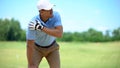 Young male golf player suffering terrible shoulder spasm after shot, trauma Royalty Free Stock Photo