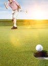 Young male golfer celebrating birdie putt