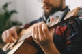 Young guitarist hipster at home with guitar capo close-up Royalty Free Stock Photo