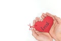 Young male hands holding a red heart shape tag with handwritten word local. Support, love, buy and campaign for local business.