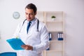 Young male handsome doctor working in the clinic Royalty Free Stock Photo