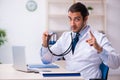 Young male handsome doctor working in the clinic Royalty Free Stock Photo