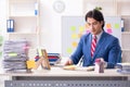 Young male handsome employee in conflicting priorities concept Royalty Free Stock Photo