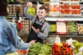 Young male is helping to buy fruit and vegetables