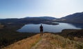 Young male hiker enjoying alpine mountain panorama of Lake Rotoiti Saint Arnaud, Nelson Lakes National Park New Zealand