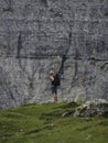 Young male hiker looking at massive rock wall of Tre Cime di Lavaredo in Sexten Dolomites South Tyrol Italy alps Europe