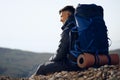 Young male hiker sitting and having a rest on a halt stop Royalty Free Stock Photo