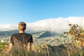 Young male hiker sitting on the summit of Diamond Head Crater in Honolulu on the Island of Oahu, Hawaii Royalty Free Stock Photo