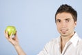 Young male holding an green apple