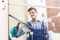 Housekeeper Cleaning Window With Squeegee Royalty Free Stock Photo