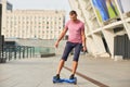 Young male on hoverboard outdoors.