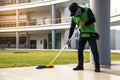 Young Male Janitor Cleaning Floor With Mopping  on modern building Royalty Free Stock Photo