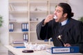 Young male judge working in courthouse