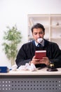 Young male judge working in courthouse