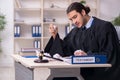 Young male judge working in courthouse