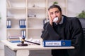 Young male judge working in courthouse