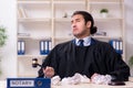 Young male judge working in courthouse