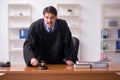 Young male judge working in the courtroom