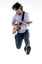 Young male jumping high holding his guitar Royalty Free Stock Photo