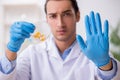 Young male lab assistant in drug synthesis concept