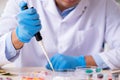 Young male lab assistant in drug synthesis concept