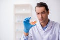 Young male lab assistant in drug synthesis concept Royalty Free Stock Photo