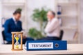 Young male lawyer and old man in testament and time management c Royalty Free Stock Photo