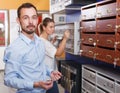 Young male looking for new reliable mailbox for home Royalty Free Stock Photo