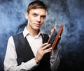 Young male make up artist holding shadow palette and brush. Royalty Free Stock Photo