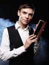 Young male make up artist holding shadow palette and brush. Royalty Free Stock Photo