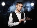 Young male make up artist holding shadow palette and brush. Royalty Free Stock Photo