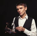 Young male make up artist holding shadow palette and brush. Royalty Free Stock Photo