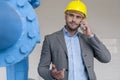 Young male manager using smart phone in industry Royalty Free Stock Photo