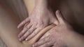 A young male masseur gives a professional massage to a client girl in a professional massage parlor. Action. Close up of Royalty Free Stock Photo