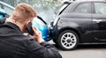 Young Male Motorist Involved In Car Accident Calling Insurance Company Or Recovery Service