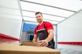 Young Male Mover Arranging The Boxes Inside The Van Royalty Free Stock Photo