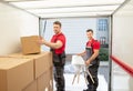 Young Male Movers Arranging The Products In Van