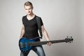 Young male musician with six-string bass guitar isolated