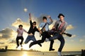 Young male musicians jumping with instruments Royalty Free Stock Photo