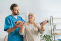 young male nurse helping senior woman Royalty Free Stock Photo