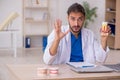 Young male odontologist working in the clinic