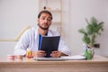 Young male odontologist working in the clinic