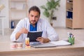 Young male odontologist working in the clinic