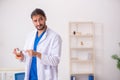 Young male odontologist working in the clinic