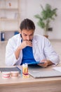 Young male odontologist working in the clinic