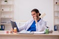 Young male odontologist working in the clinic